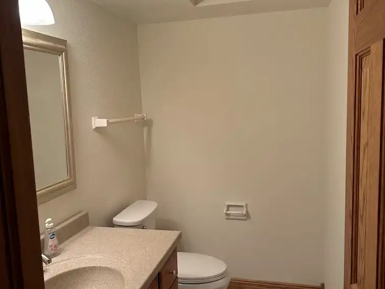 Freshly painted bathroom after removing wallpaper.