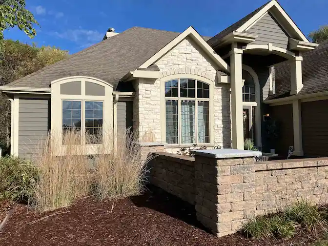 Painting a home with cedar siding.